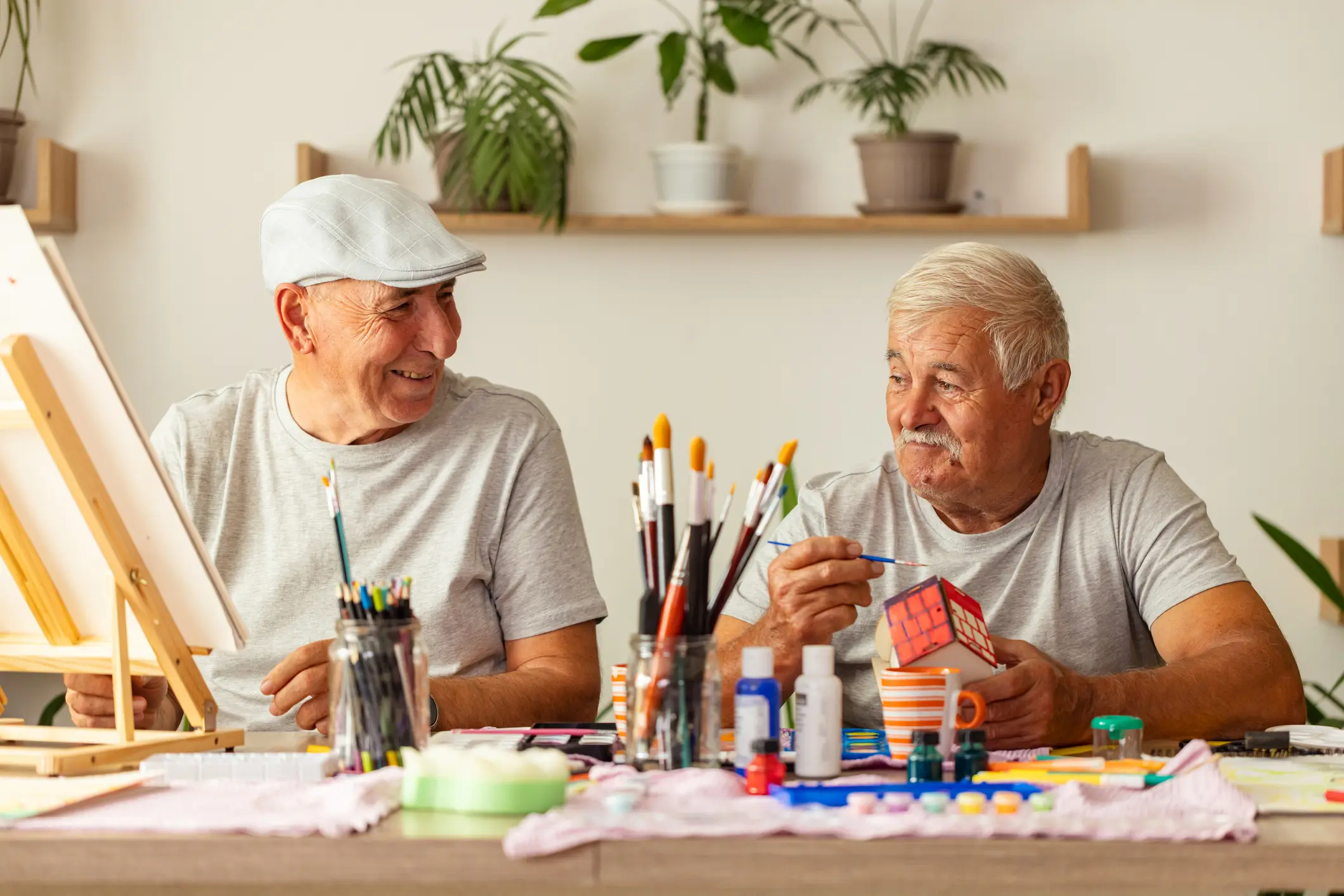 Senior men enjoying painting together
