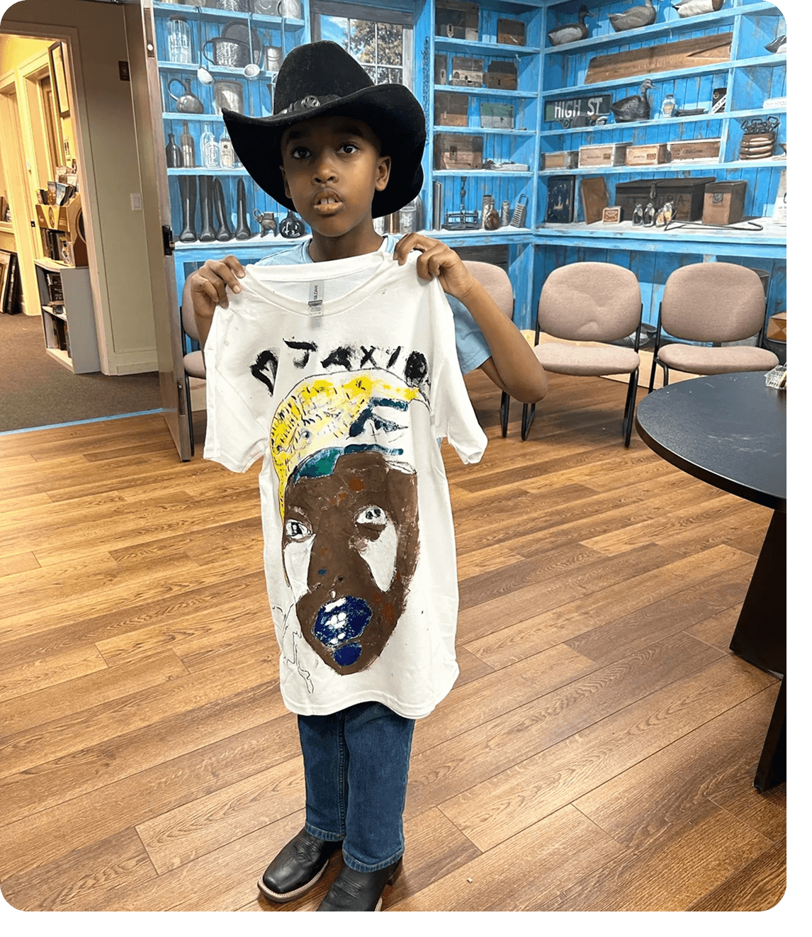 Boy wearing cowboy hat with artwork