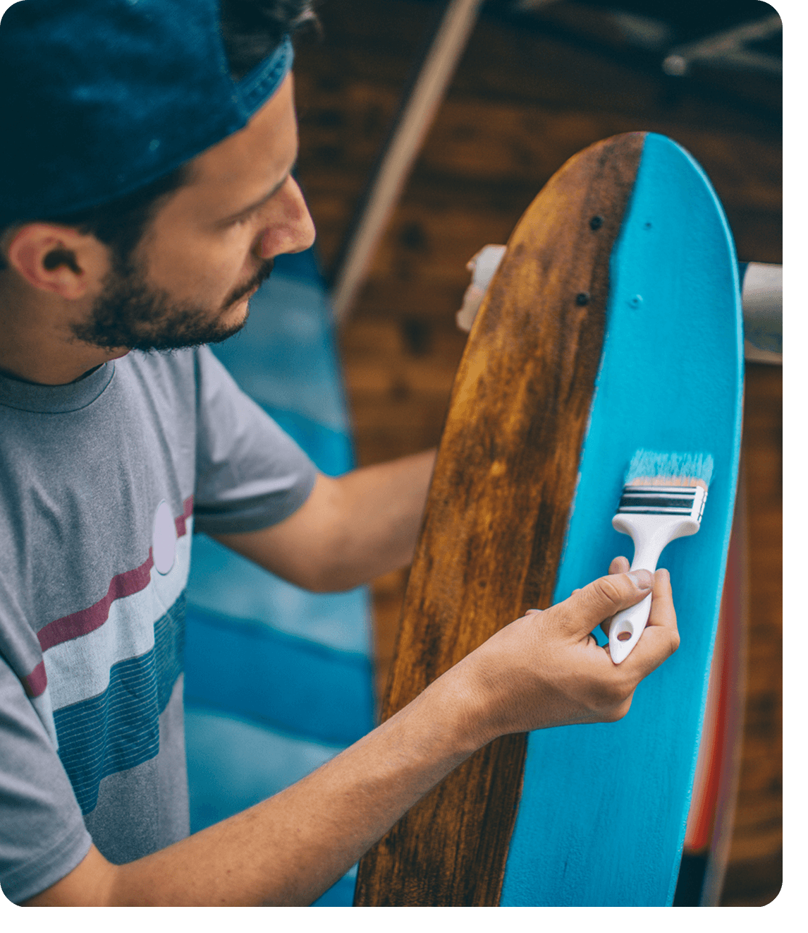 Person applying paint to skateboard