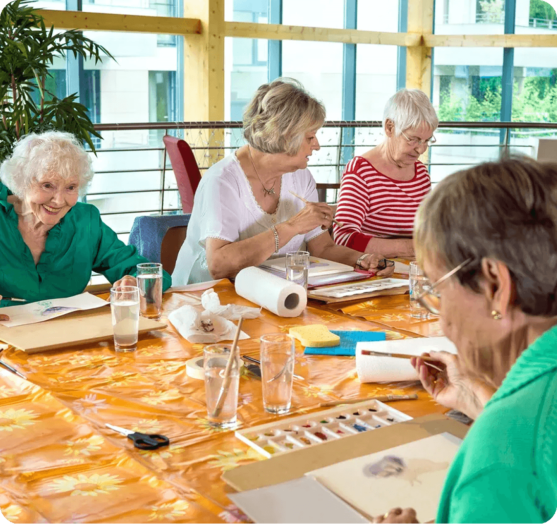 Art session with senior women painting