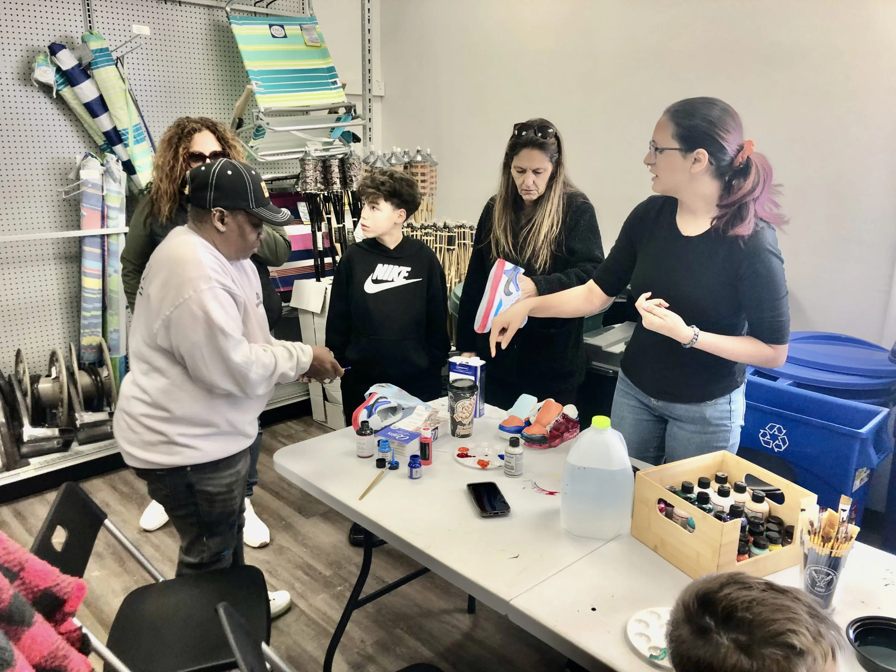 People gathered around a table crafting patriotic decorations.